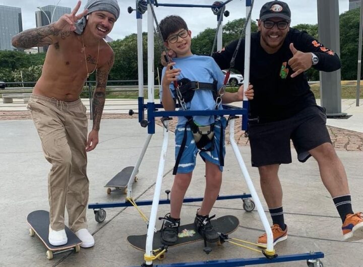 Skateboarder helping kids with disaabilities