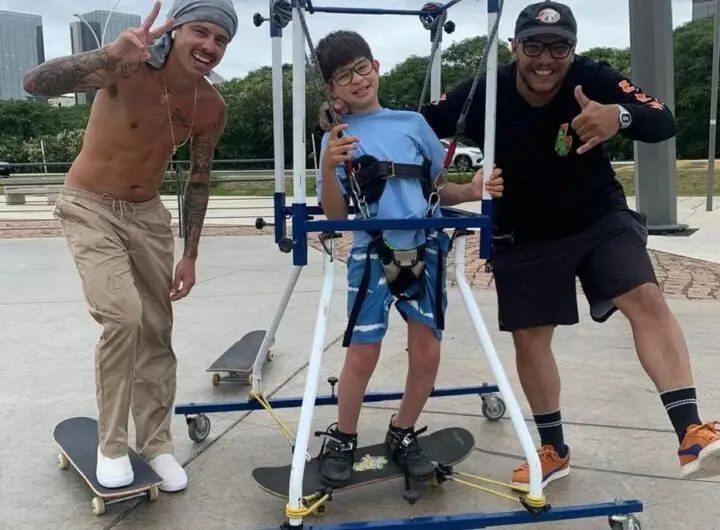 Skateboarder helping kids with disaabilities